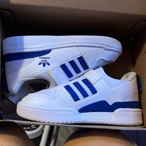 Blue and white Velcro slide on Adidas